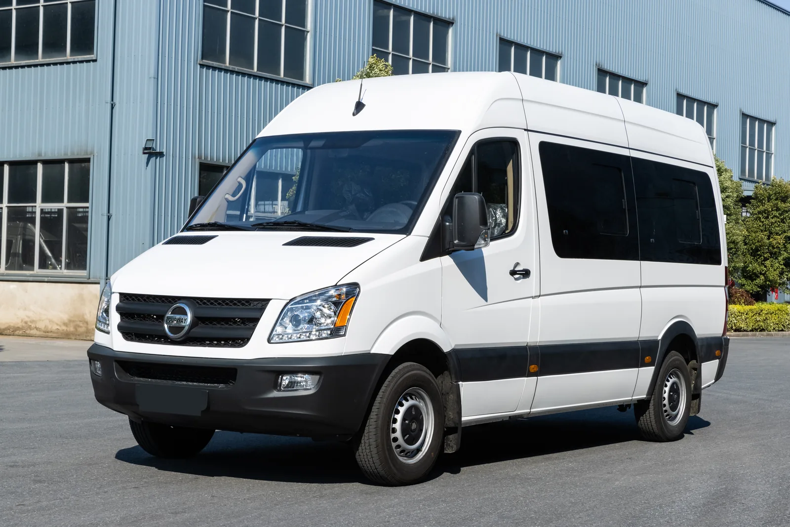 Front three-quarter view of white TOURWAY T6 commercial vehicle